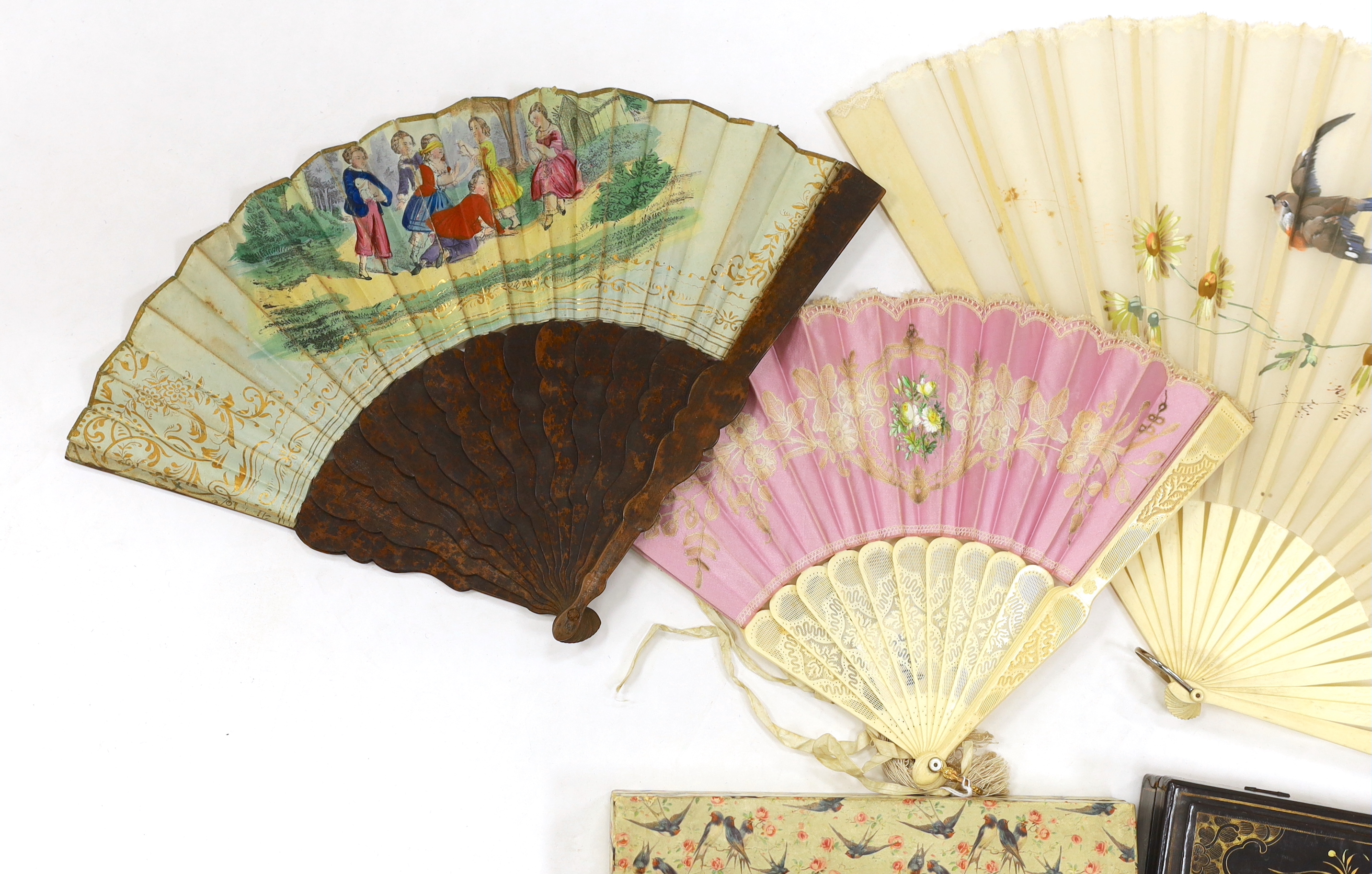 A Chinese lacquer fan box and a paper covered fan box, two Victorian fans painted with scenes of children playing, a gauze painted fan and another with bobbin lace appliqué, lacquer box 32cm wide x 4.5cm high